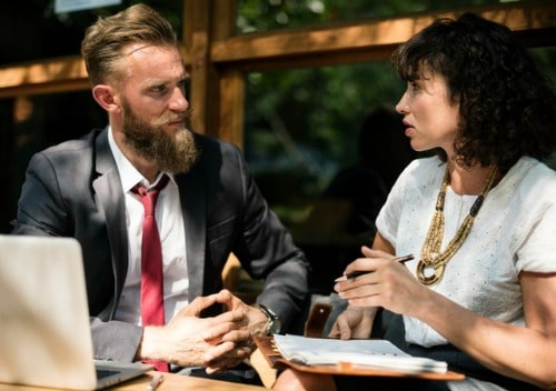 man and woman sitting outside talking