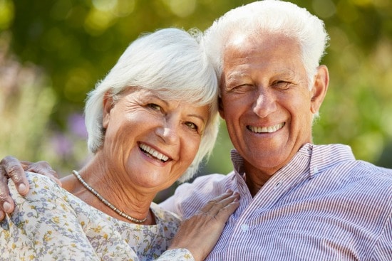 senior couple smiling at camera