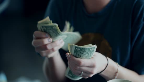 woman counting dollar bills